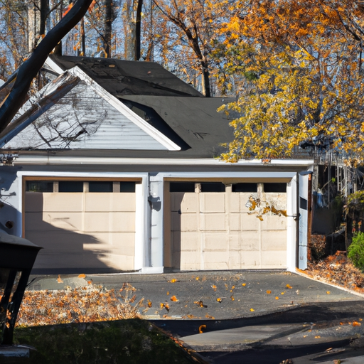 Two-car garage door on a suburban home in Upper Saddle River, NJ, with visible tracks and driveway, autumn light.